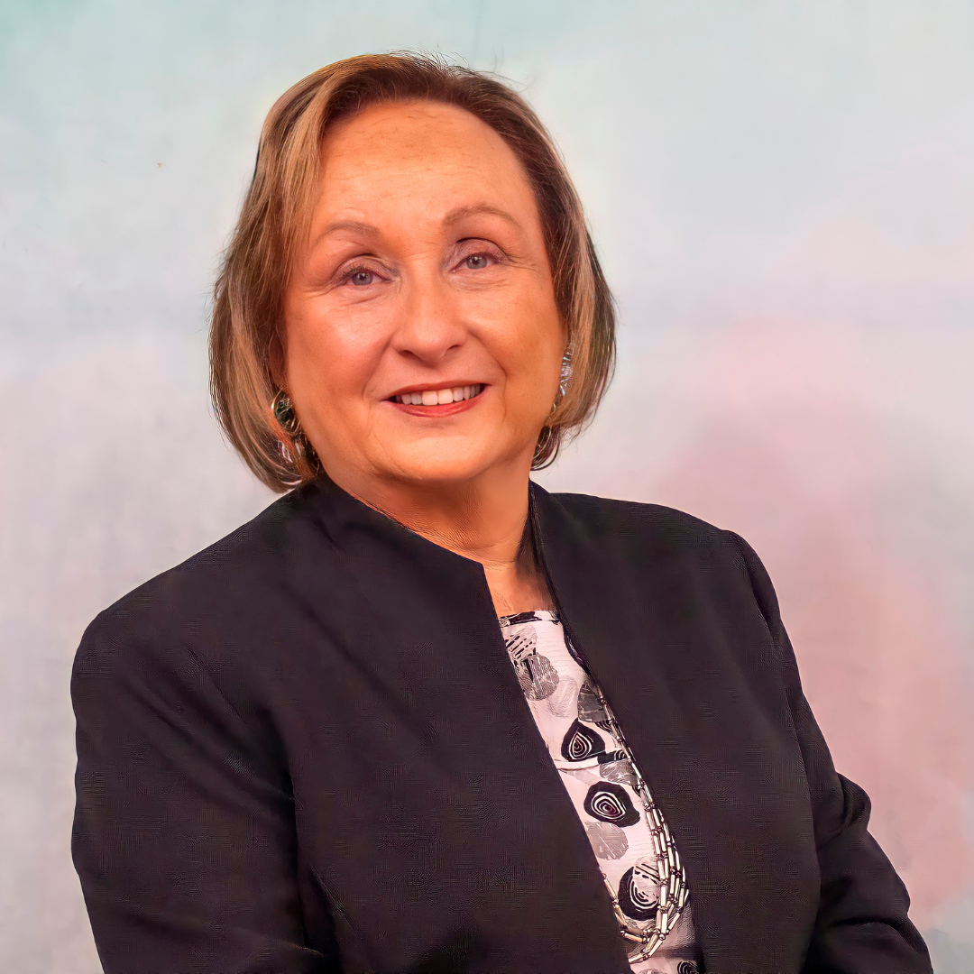 a woman wearing a black jacket and a white shirt smiles for the camera