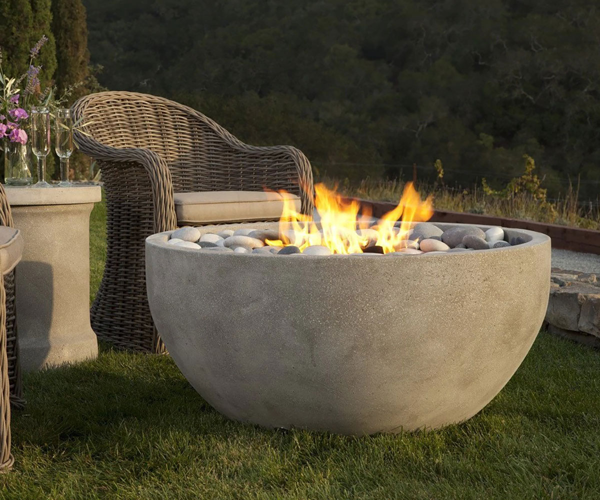 Round outdoor gas fire pit in Aurora backyard