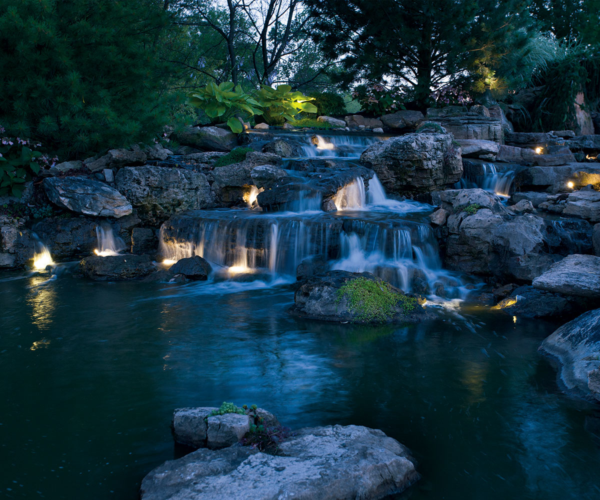 Waterfall and landscape boulder lighting in Canal Fulton Ohio backyard pond