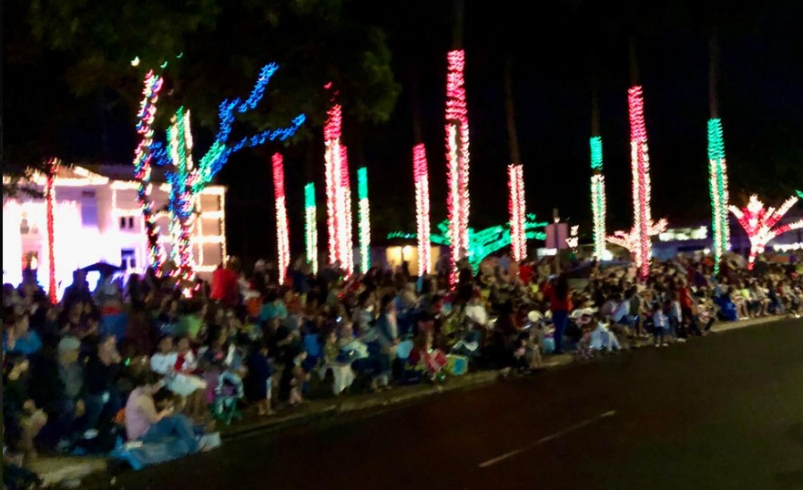 Christmas lights and parade goers at the Lights on Rice Christmas Parade in Kauai, HI