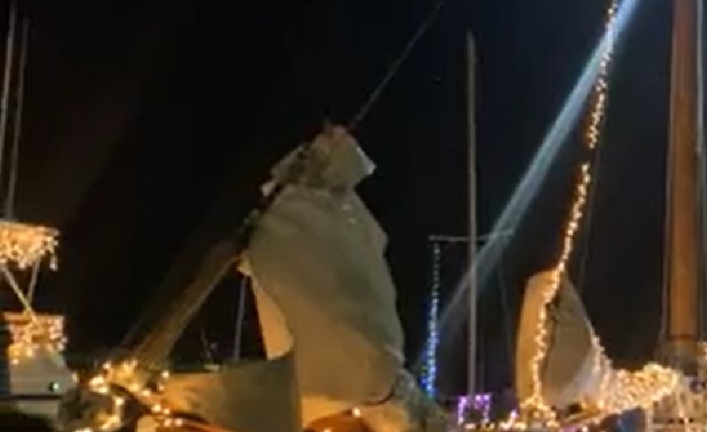 Boats decorated with Christmas lights at the Lighted Boat Parade in Key West, FL