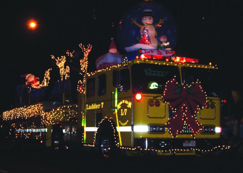 A firetruck decorated for Christmas rides in the Waikiki Holiday Parade in Honolulu, Hawaii