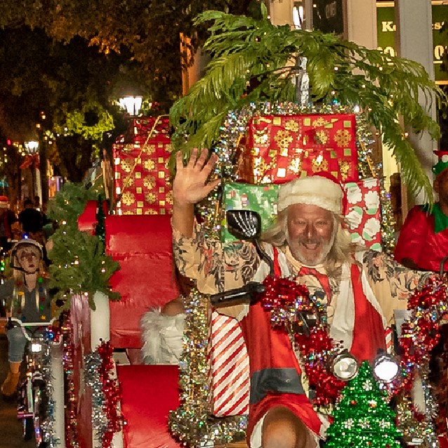 Santa Clause rides a bike decorated with Christmas lights in the BeLighted Bike Ride in Key West, Florida