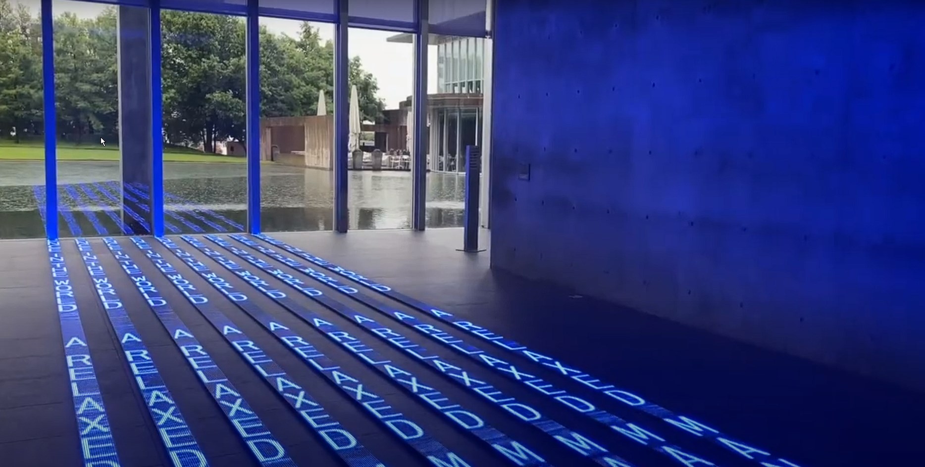 Art installation blue words projected on the floor at the Modern Art Museum of Fort Worth