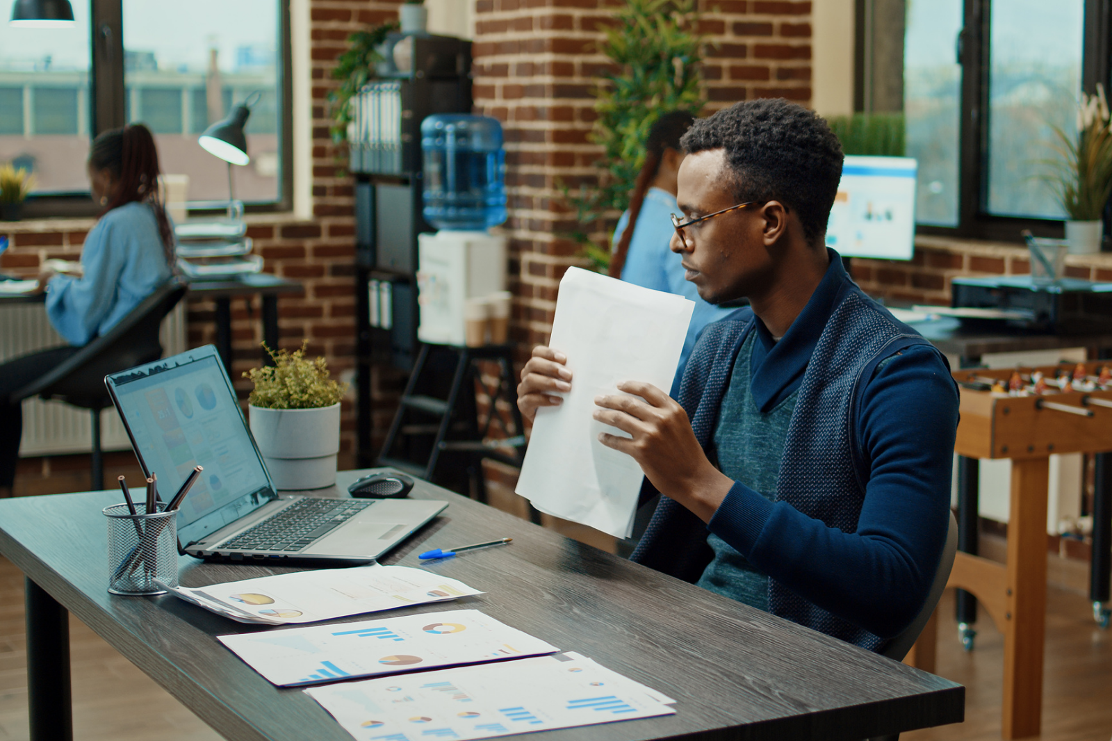 African American man working at desk on reports