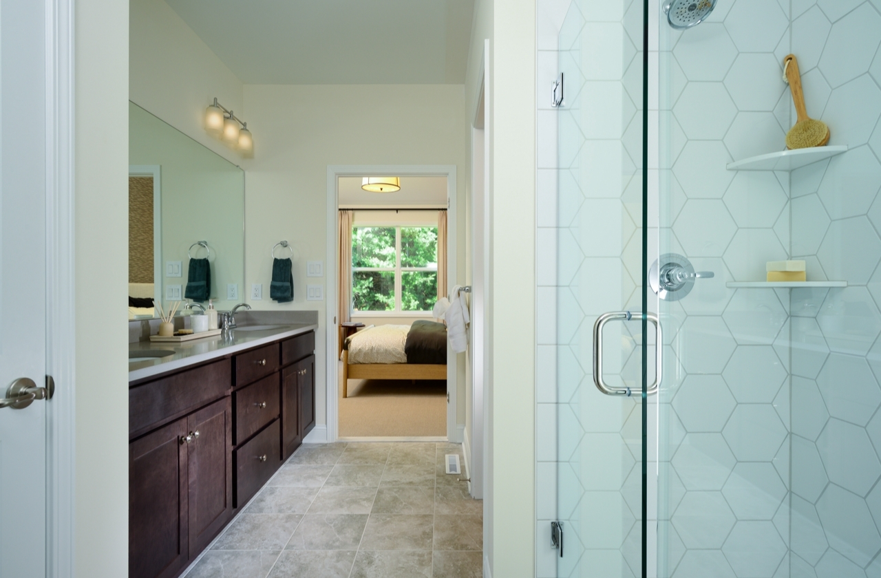 Cypress Ranch - Primary bathroom featuring tiled shower with frameless shower door
