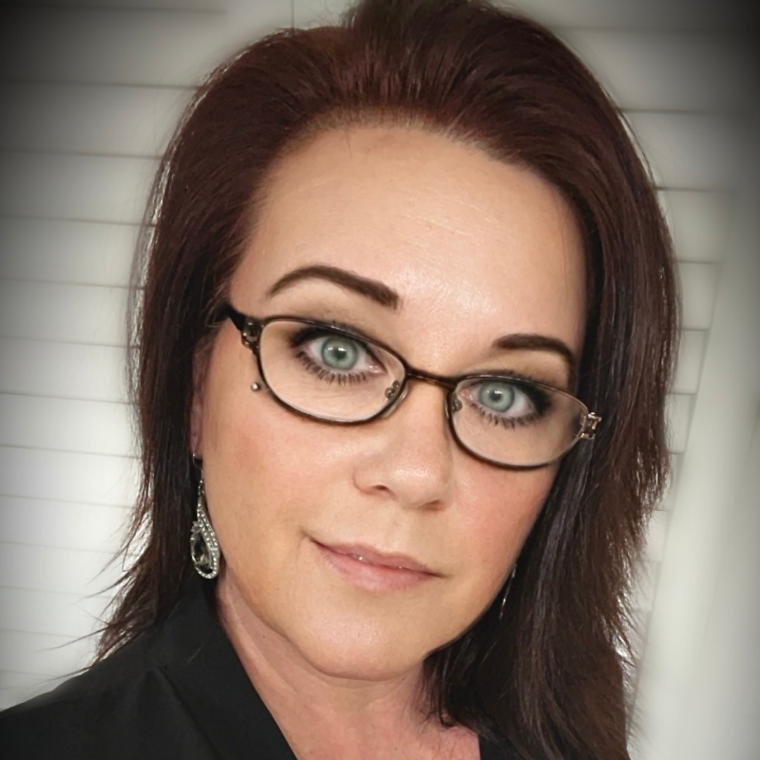 a woman wearing a black jacket and a red scarf is smiling for the camera .