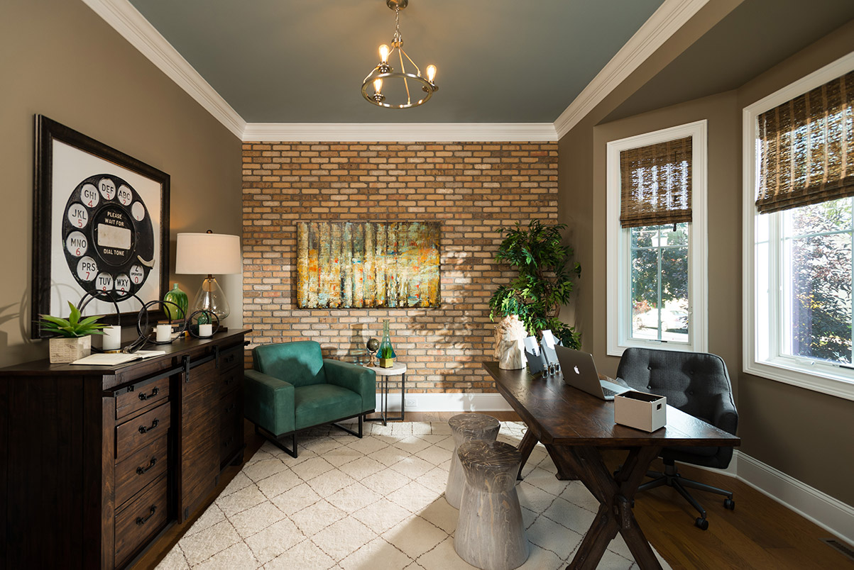 Luxury Townhome - Formal study featuring pocket doors and a unique brick accent wall