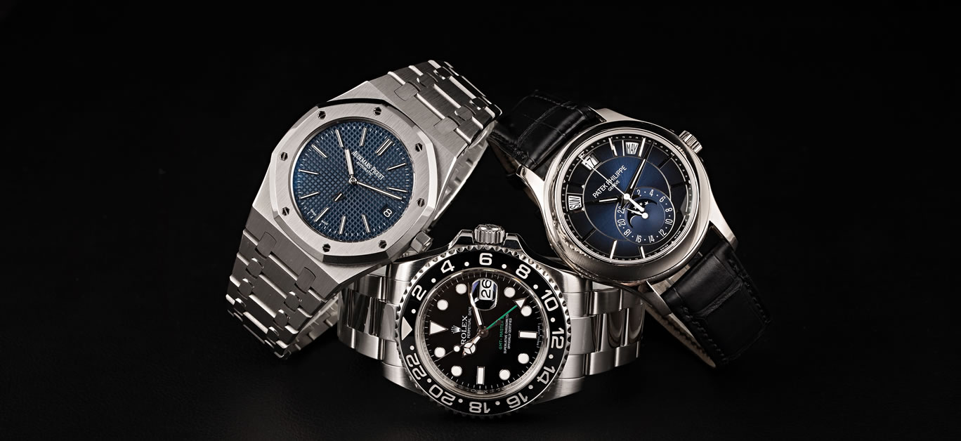 An Audemars Piguet and Patek Philippe leaning on a Rolex