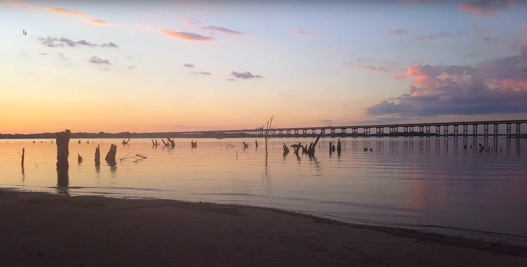 View of the sunrise on Lake Waco in Waco, TX with a bridge in the background