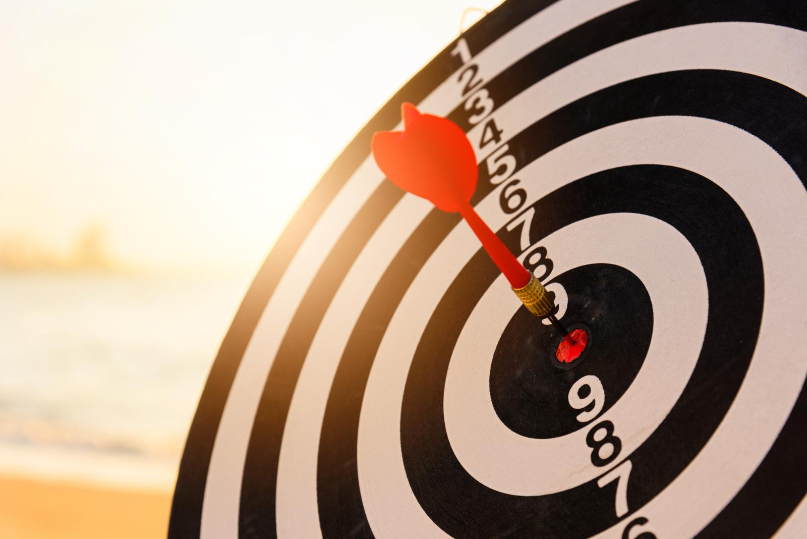 dartboard with a dart stuck in the bullseye