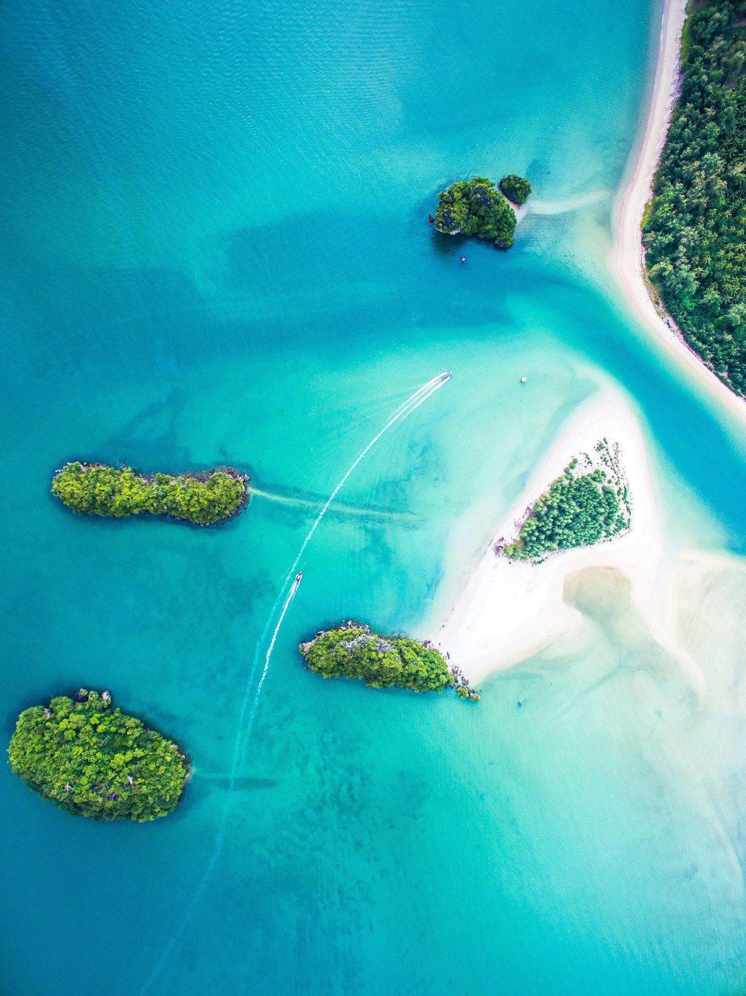 Aerial shot of Thailand's lush islands, white beaches, and turquoise waters