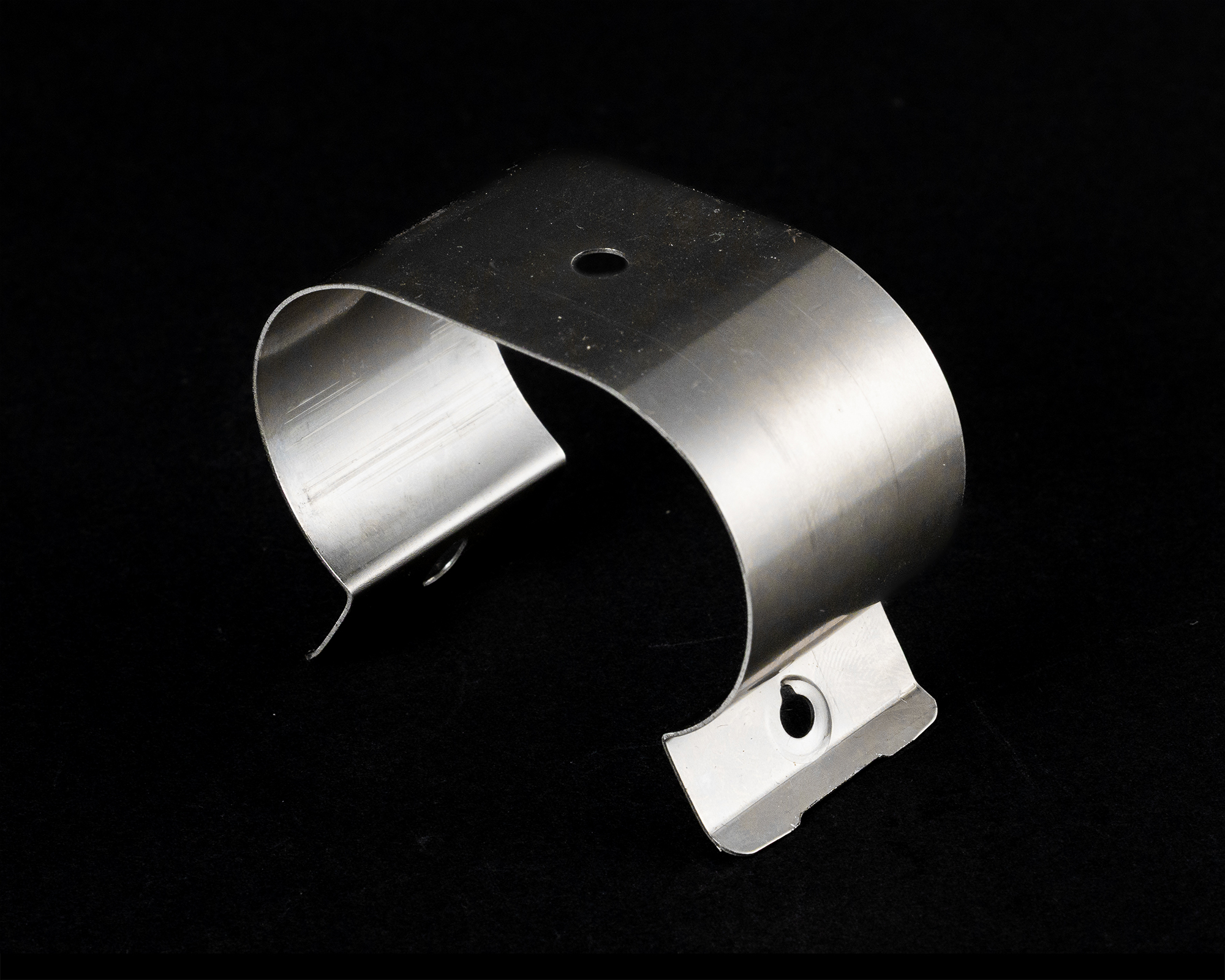 Coiled springs of varying sizes and colors on a black background, including copper, gold, black, and silver.