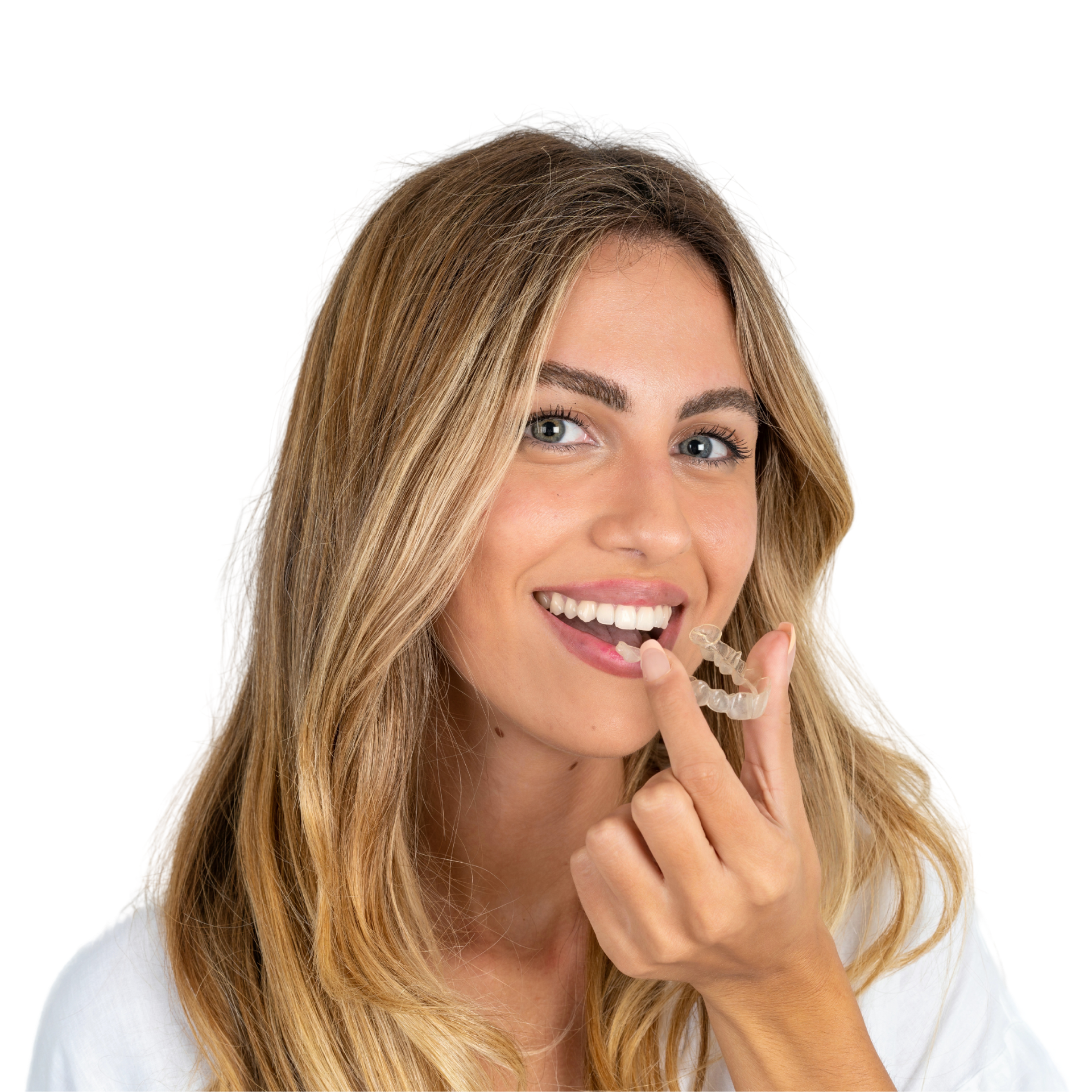 A woman with long hair is smiling with her hands on her face.