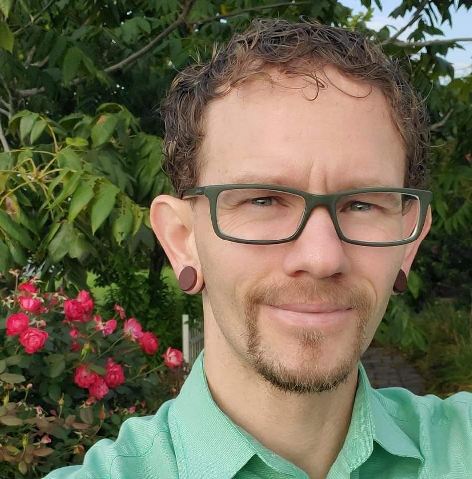 A woman is examining a man 's head in a lab