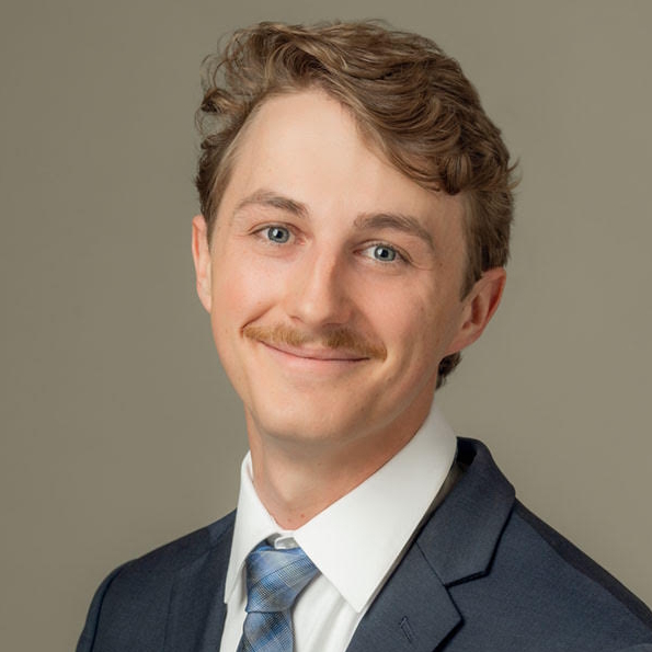 A woman is examining a man 's head in a lab