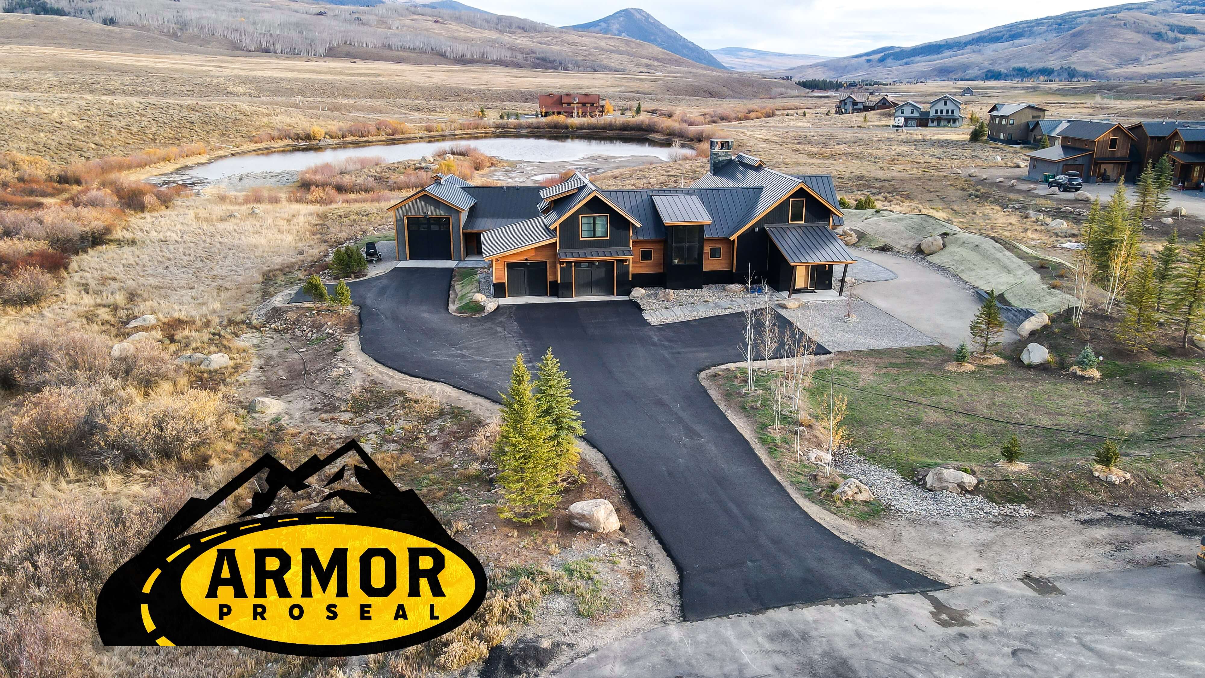 Commercial parking lot resurfacing project in Gunnison, CO, with Armor Proseal's equipment and crew delivering durable, weather-resistant asphalt surfaces for high-altitude business locations.