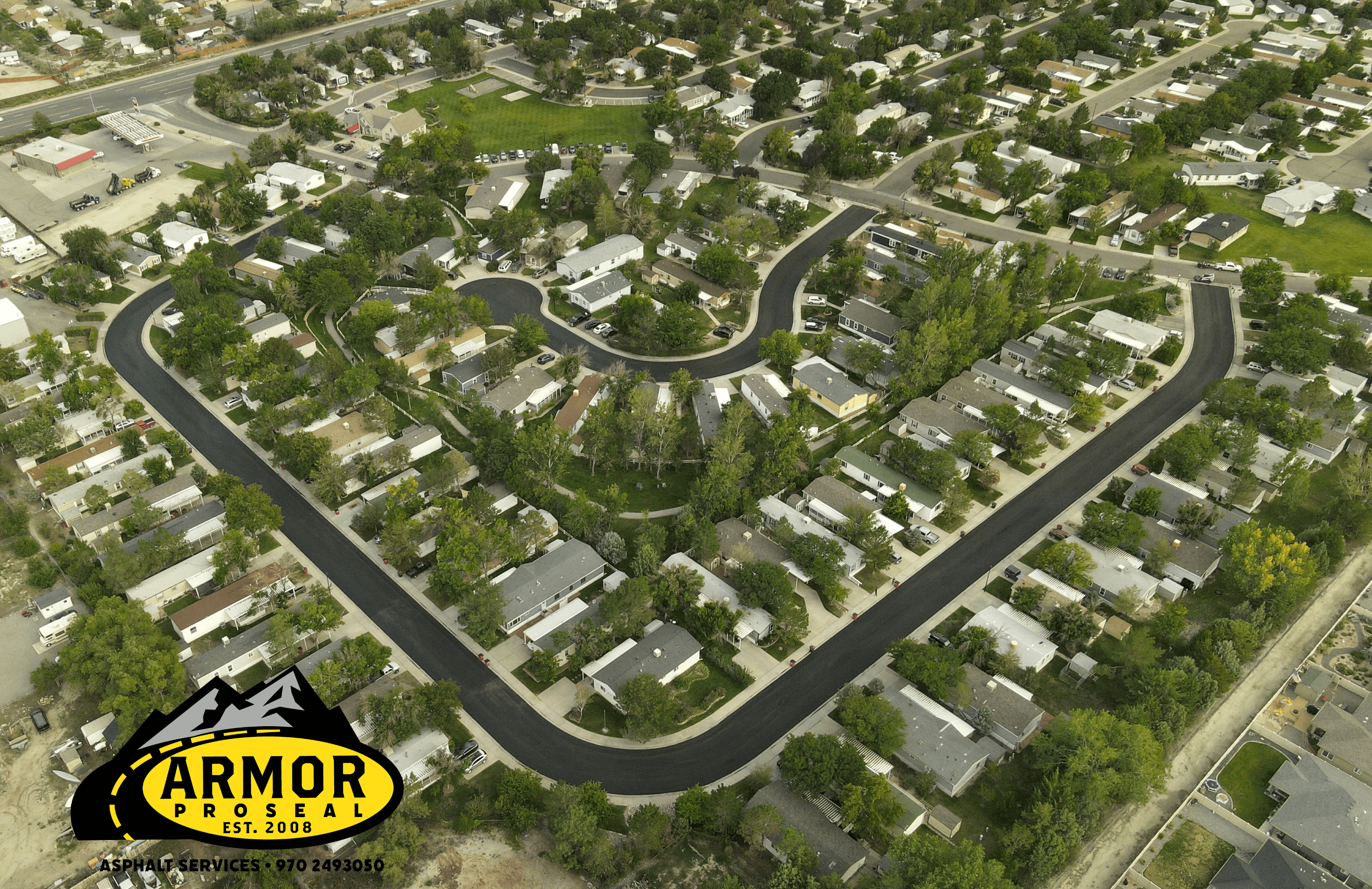 Historic district street maintenance in Helper, UT, with Armor Proseal crew performing careful asphalt repairs that preserve community character while improving infrastructure.