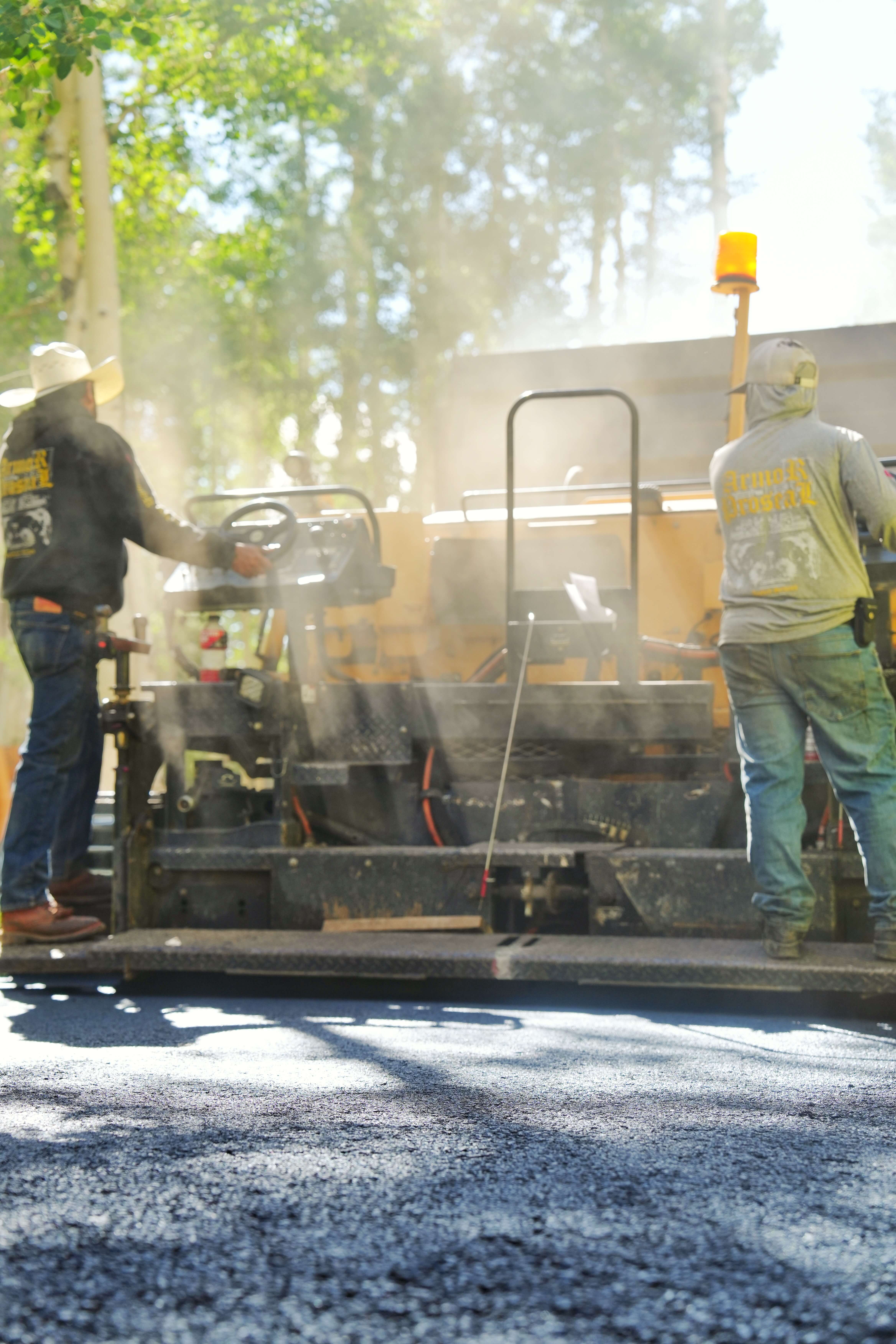 Armor Proseal equipment paving an agricultural facility access road in Olathe, CO, providing durable surfaces designed for heavy equipment and seasonal farming operations.