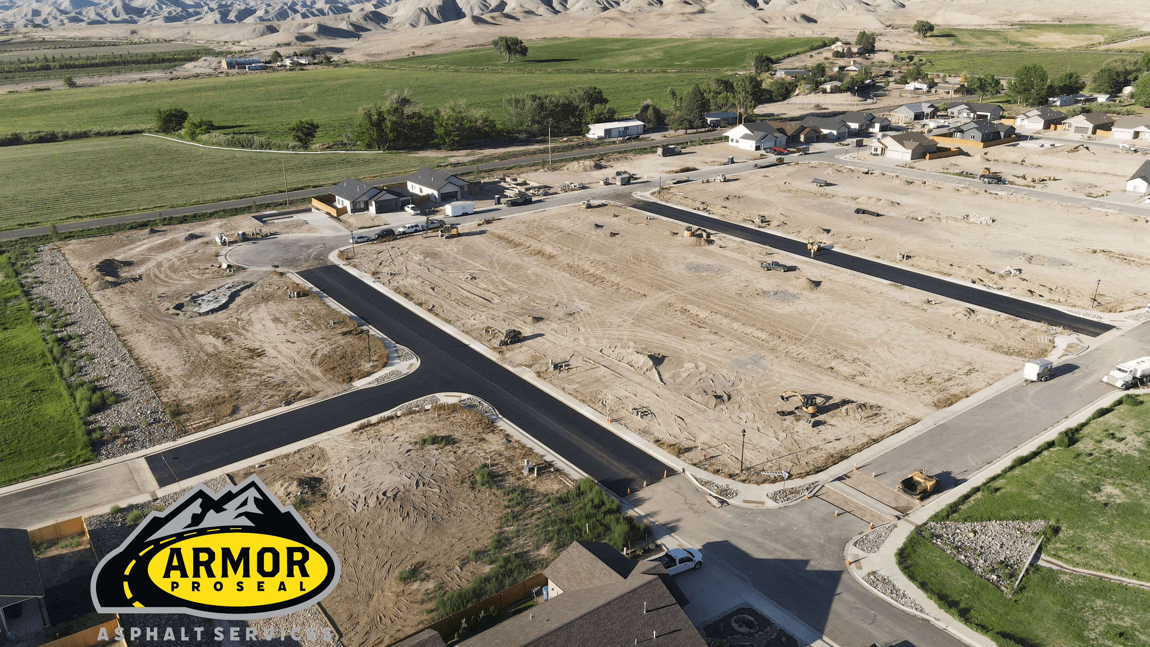 Aerial view of a new development in Ridgway, CO, showcasing Armor Proseal's precision asphalt paving work with newly installed roadways and infrastructure ready for construction.