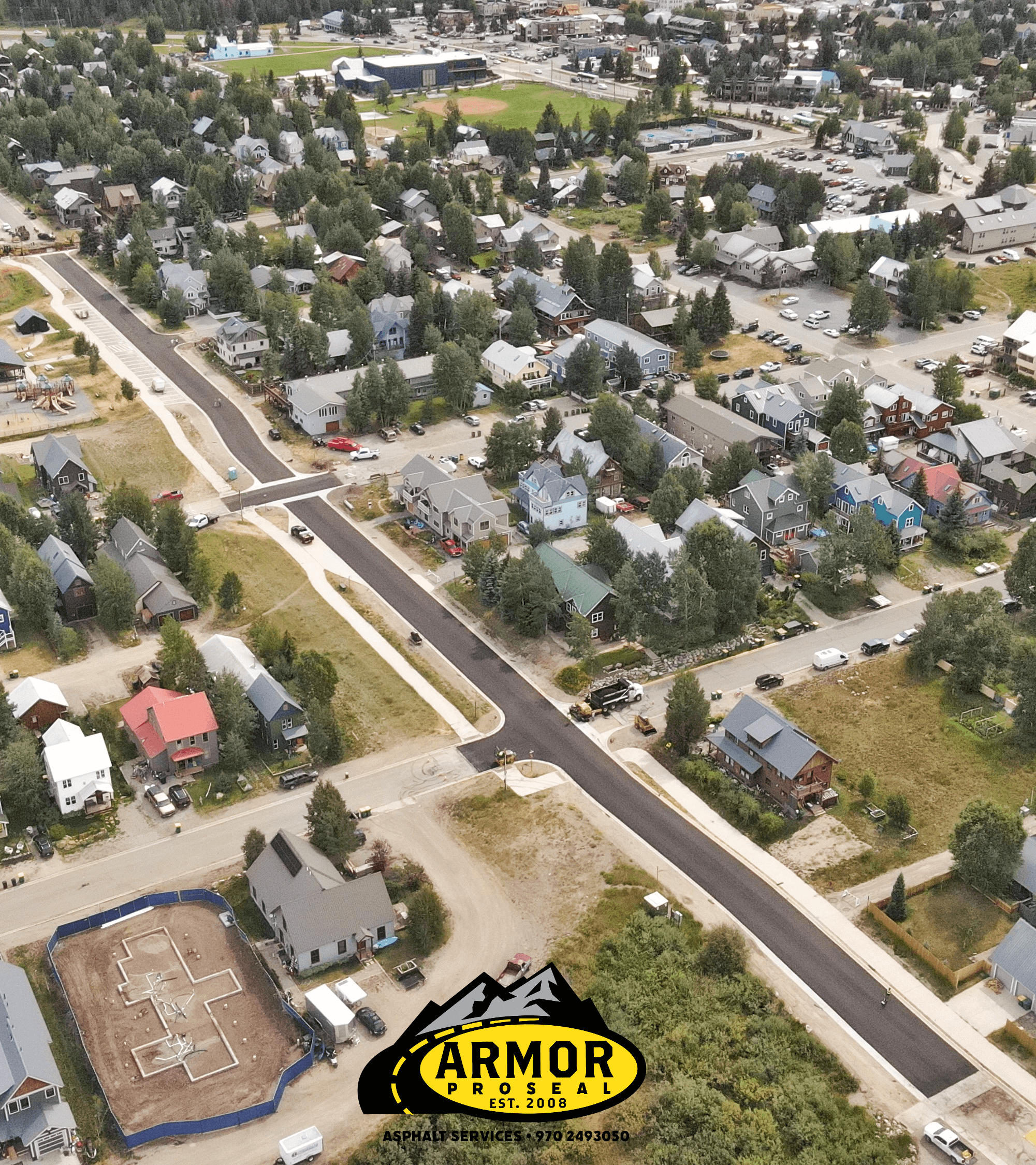 Fresh commercial driveway installation in Craig, CO, with Armor Proseal equipment and crew creating a professional entrance that enhances business appearance and functionality.