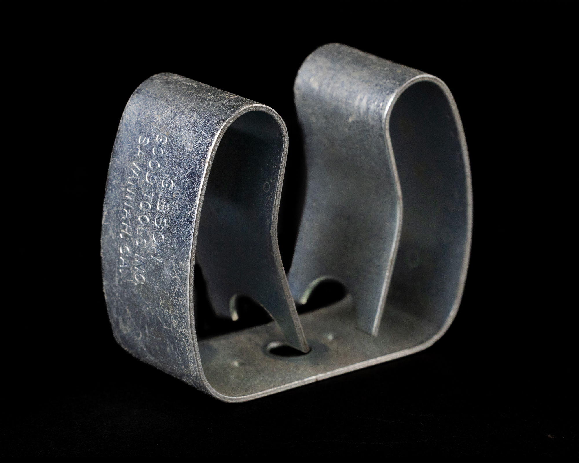 Golden coil spring against a black background.