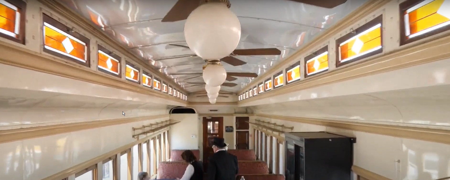 Inside a Grapevine Vintage Railroad car with stained glass and ceiling fans in Grapevine TX