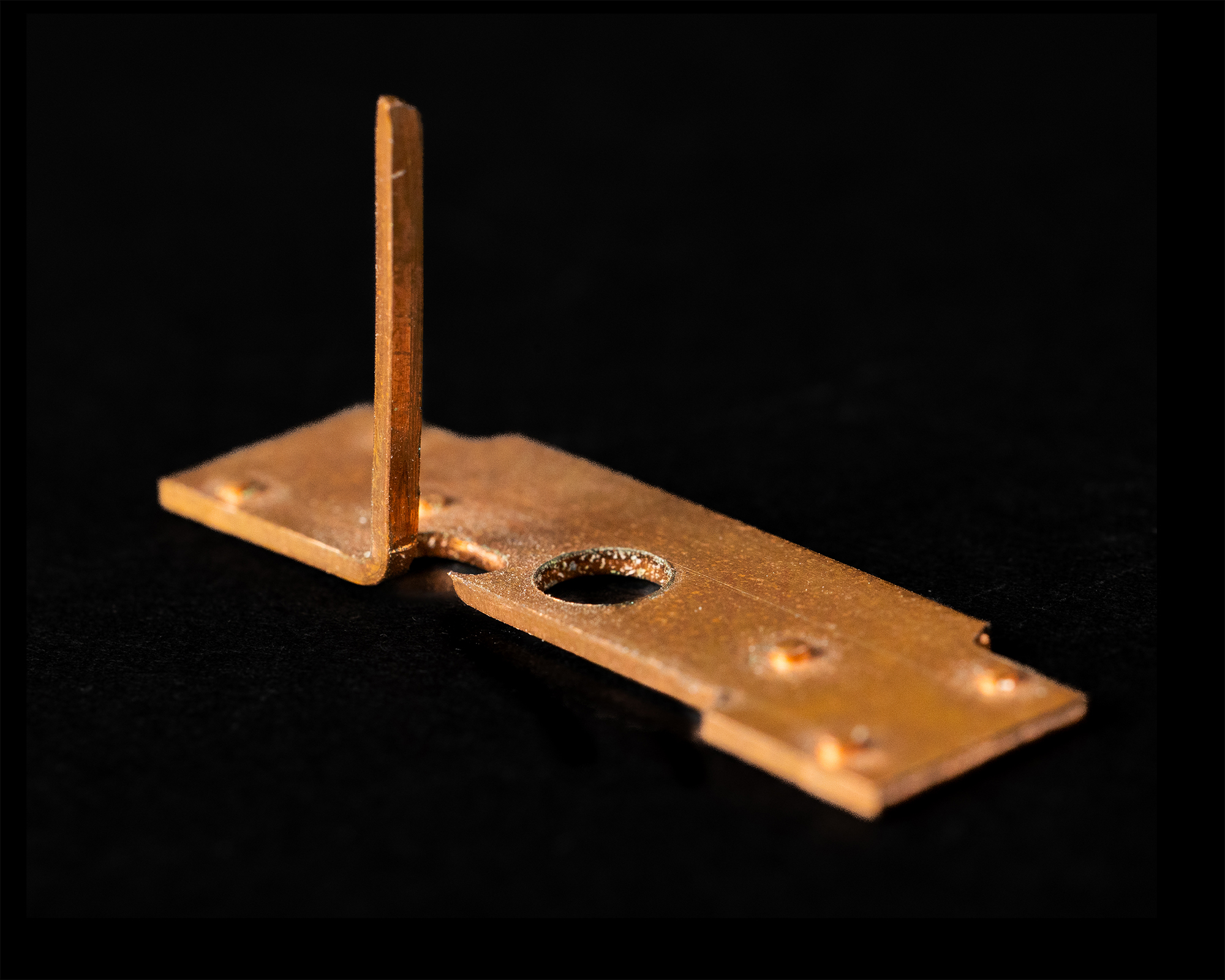 Golden coil spring against a black background.