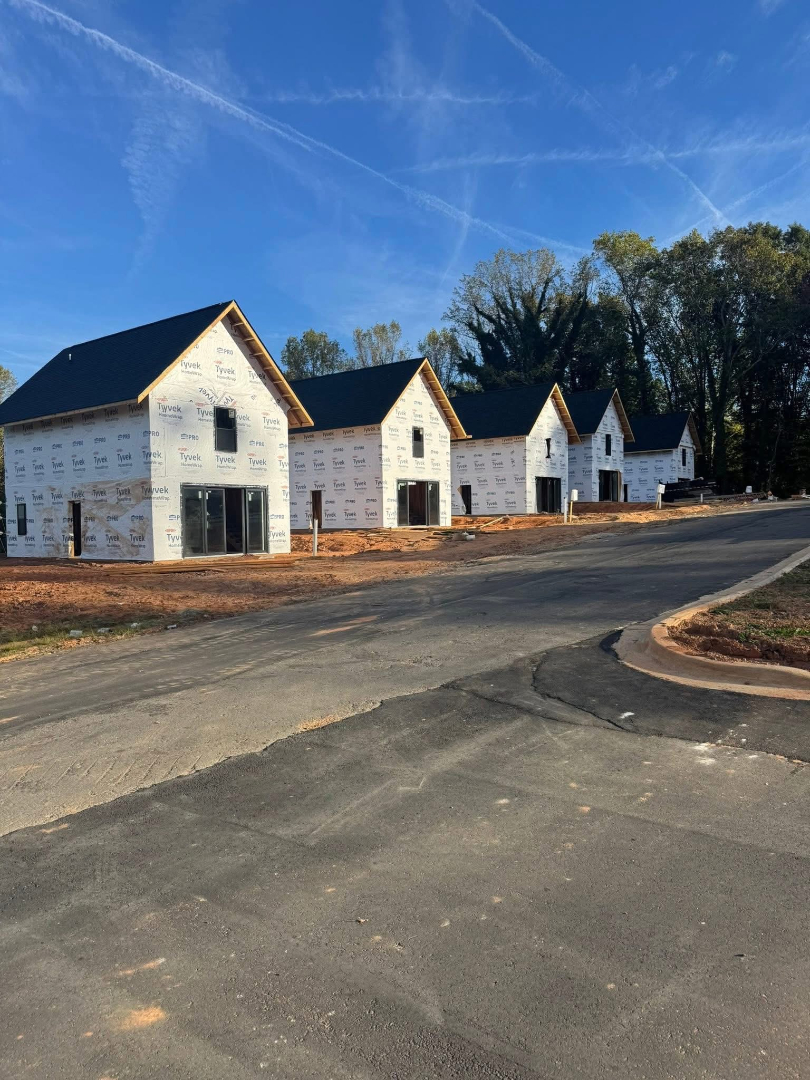 Row of newly constructed residential buildings under development by Foothills Construction and Restoration Services in Asheville, North Carolina. Phone (828) 484-0160.