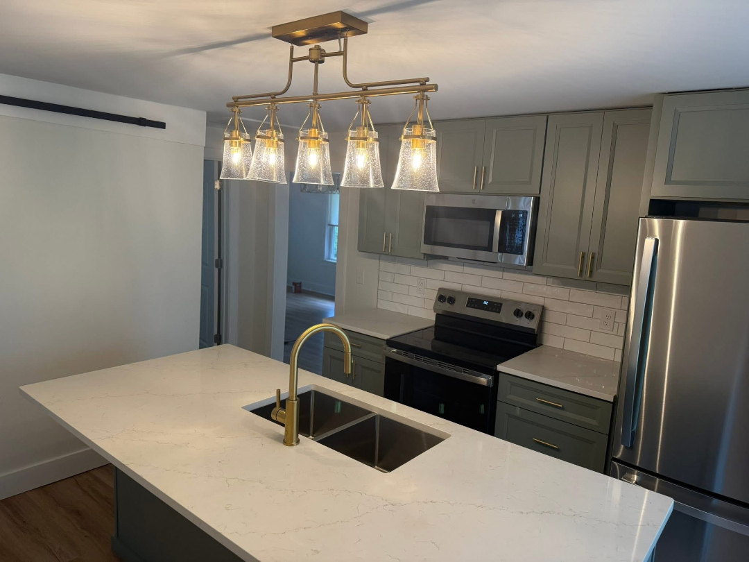 Completed kitchen renovation with updated cabinets, countertops, and lighting by Foothills Construction and Restoration Services in Spruce Pine, NC. Phone (828) 489-3966.