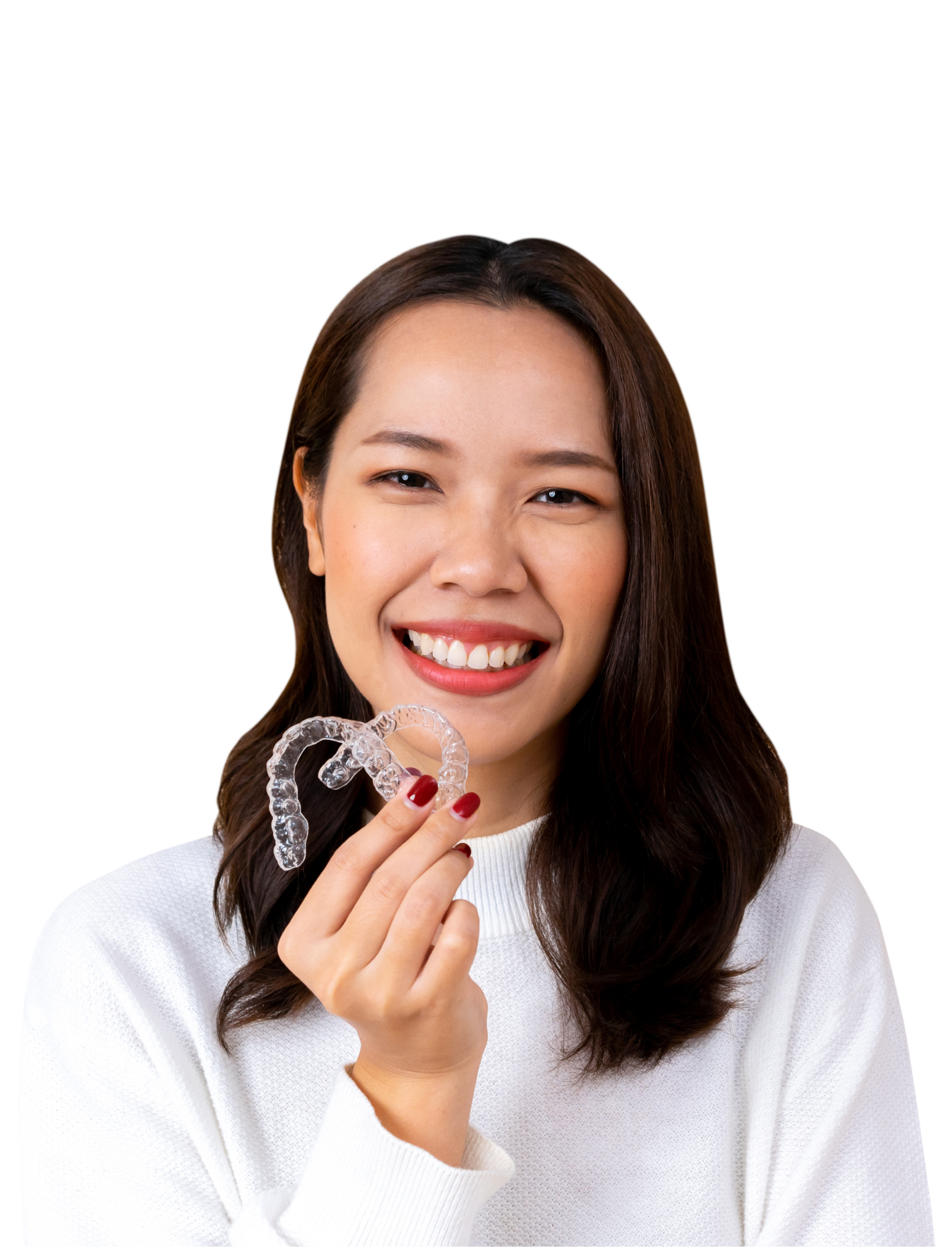 A woman in a white shirt is smiling with her hand on her chin