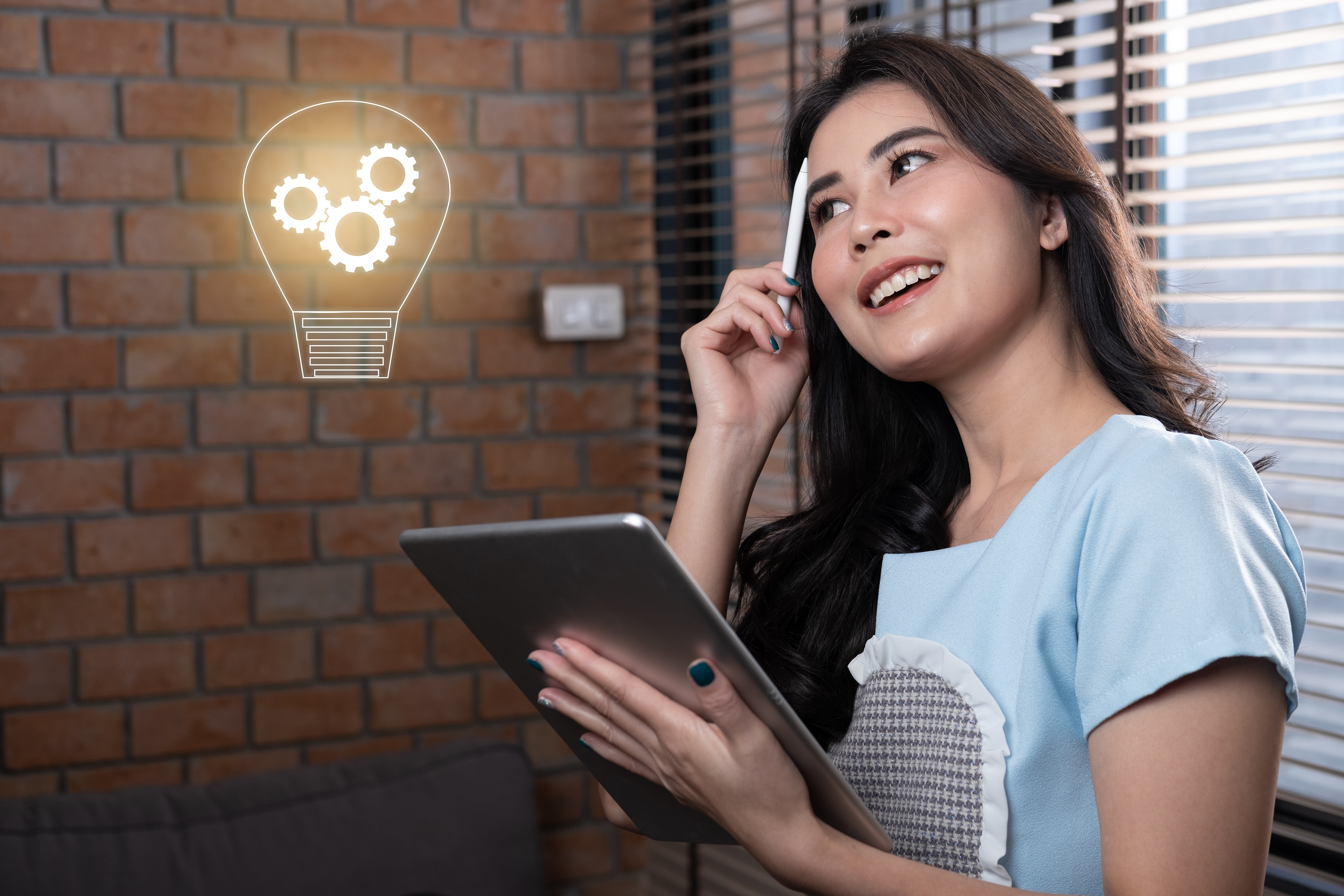 smiling-young-woman-using-phone-while-standing-against-brick-wall.jpg