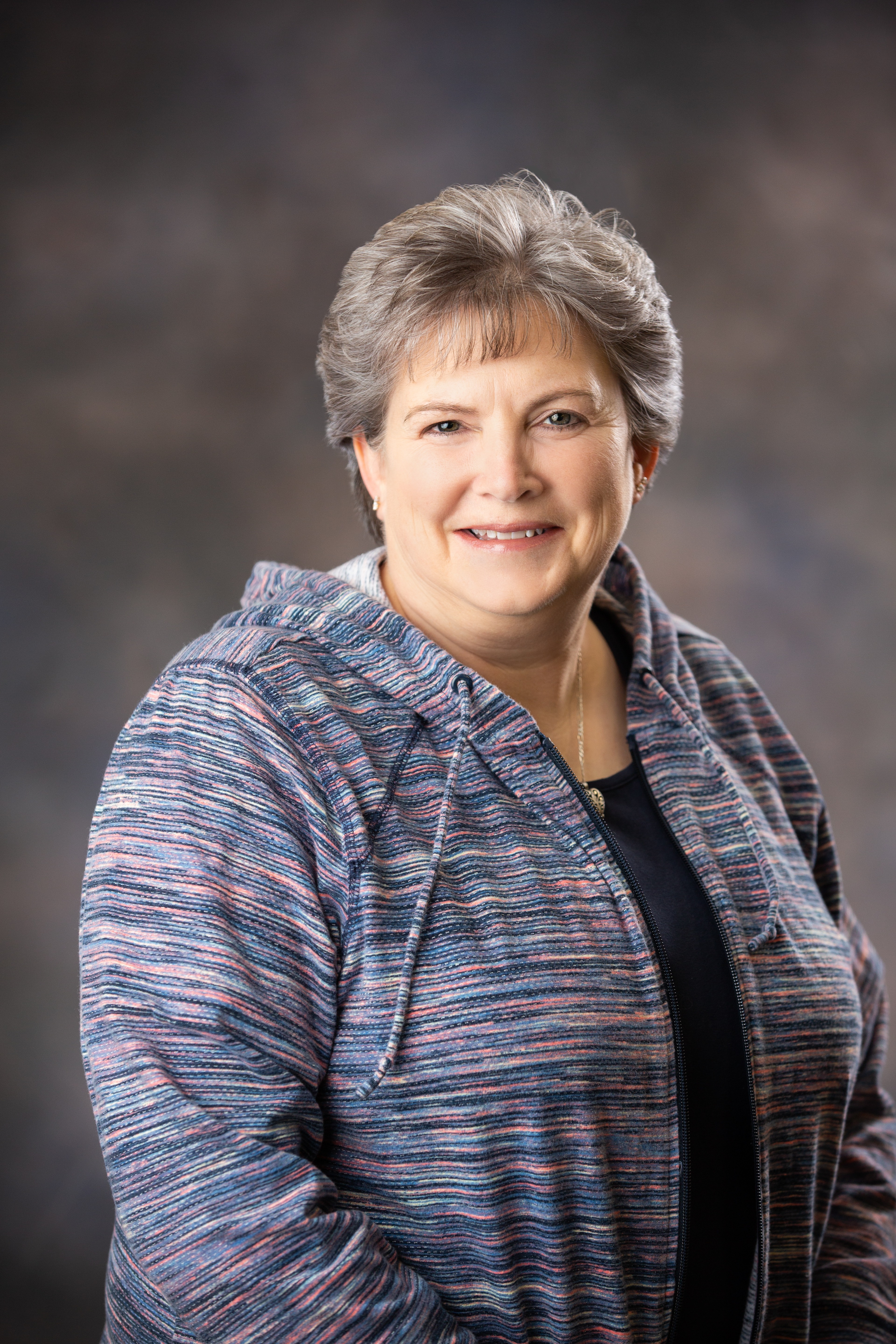 A woman is examining a man 's head in a lab
