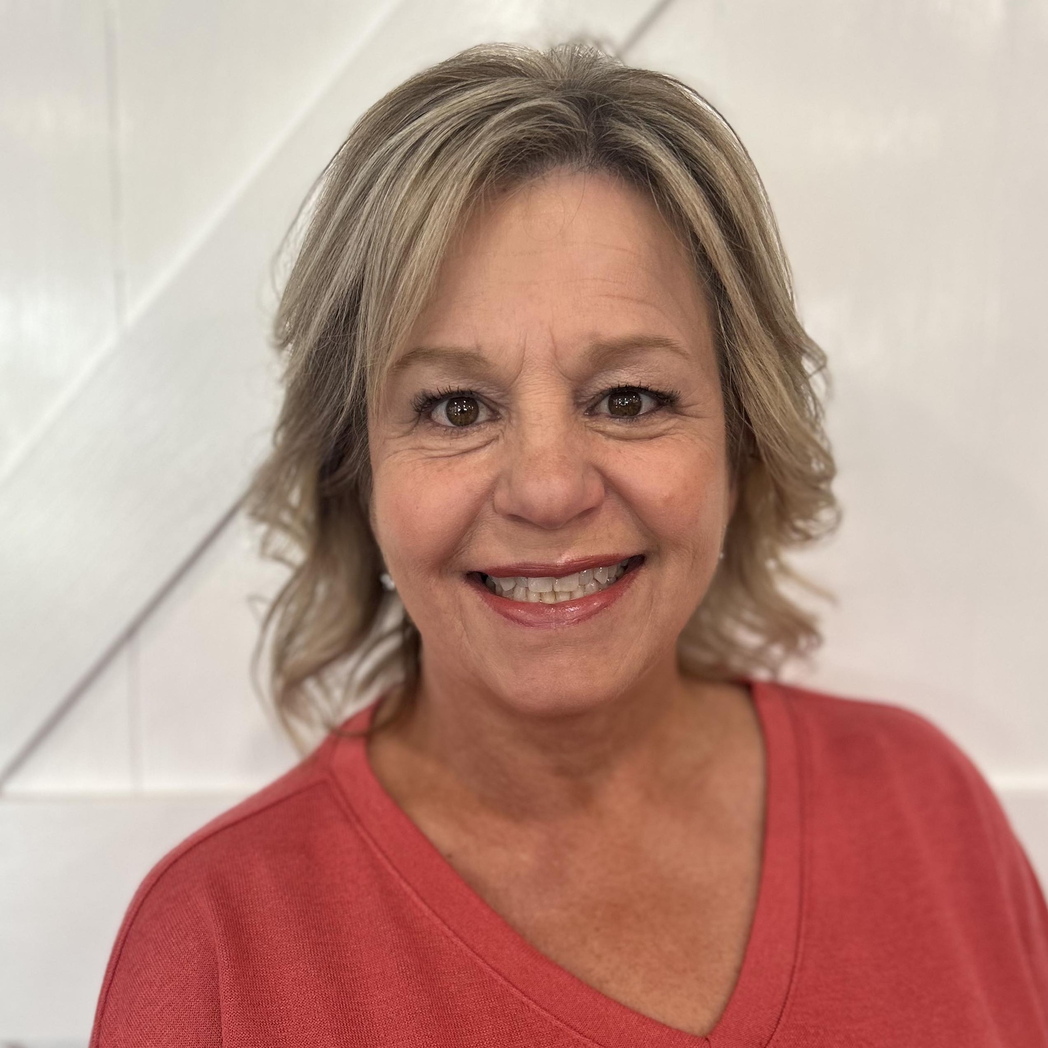 A woman is examining a man 's head in a lab