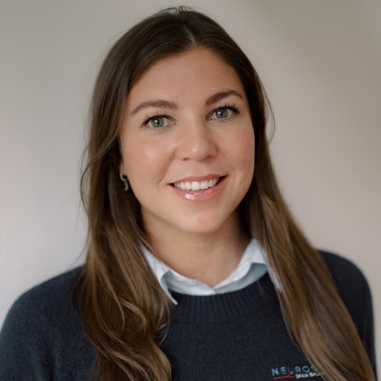A woman is examining a man 's head in a lab