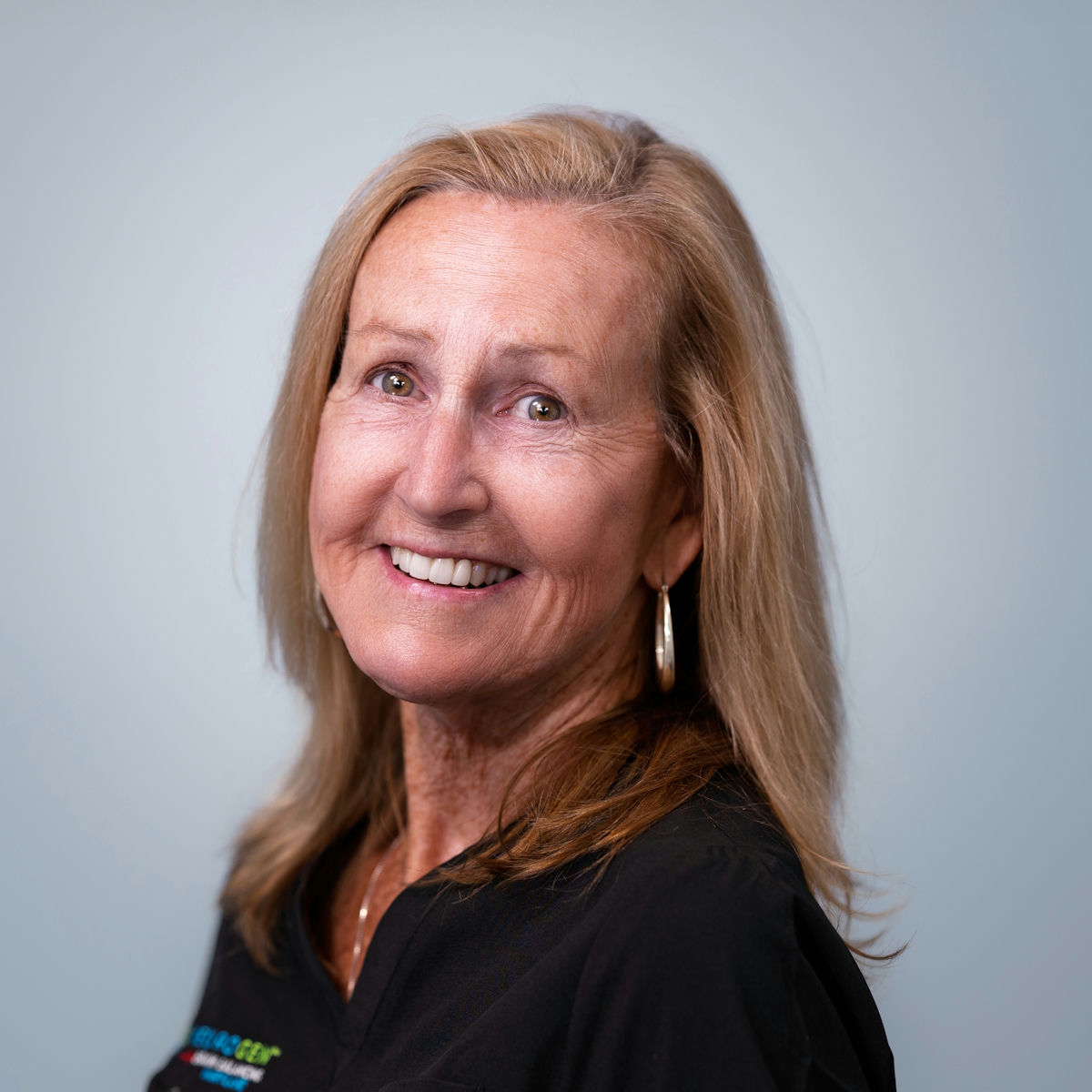 A woman is examining a man 's head in a lab