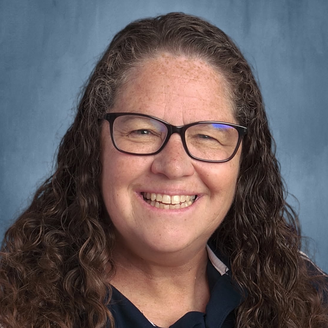A woman is examining a man 's head in a lab