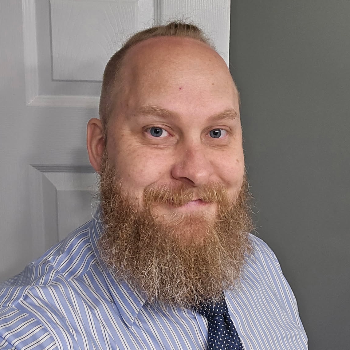 A woman is examining a man 's head in a lab