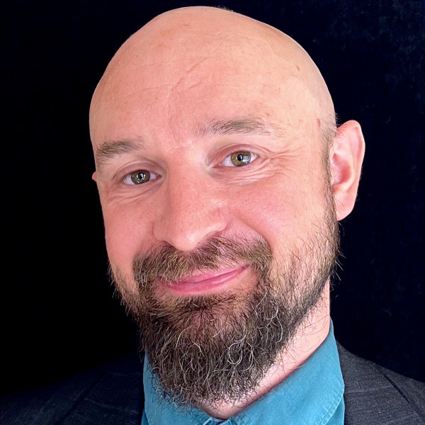 A woman is examining a man 's head in a lab