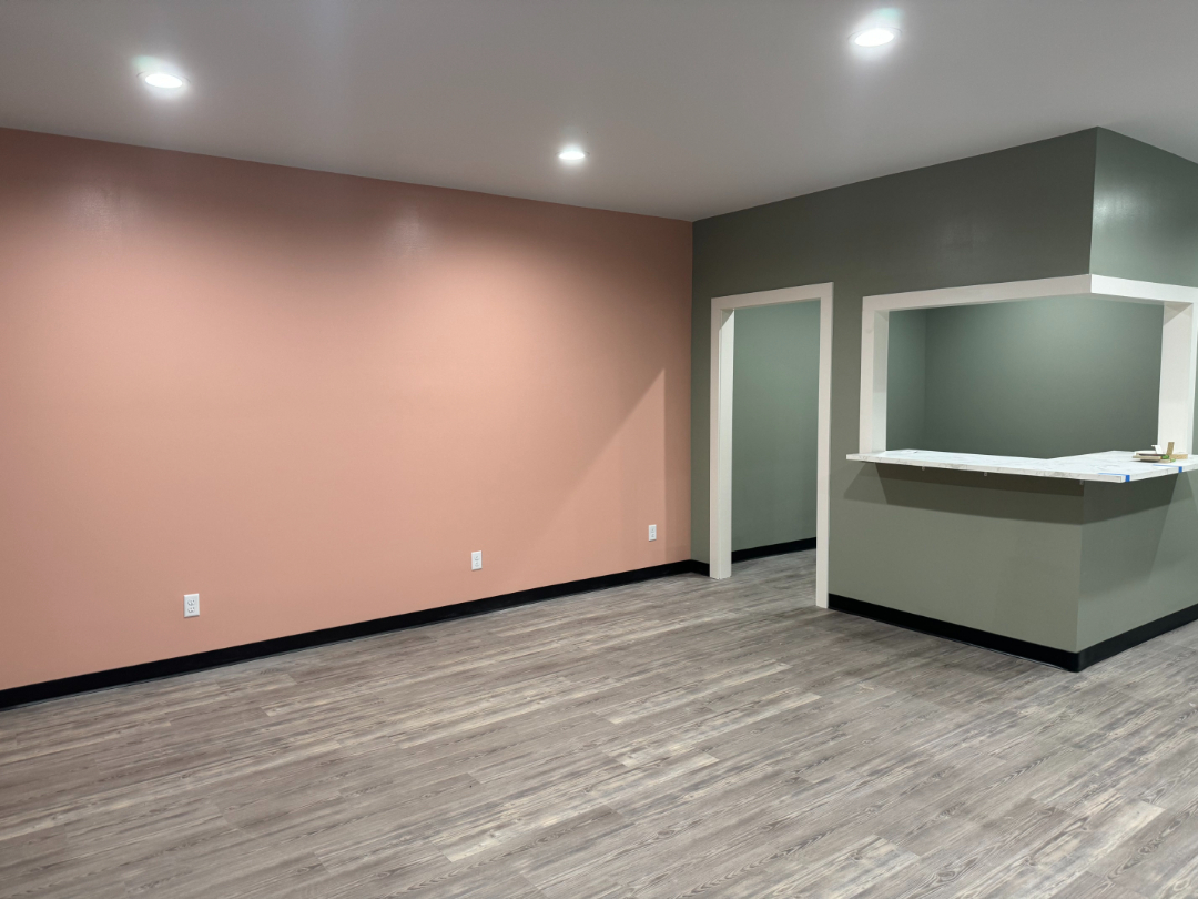 Finished commercial interior with new flooring, painted walls, and service counter completed by Foothills Construction and Restoration Services in Morganton, NC. Call (828) 373-1194.