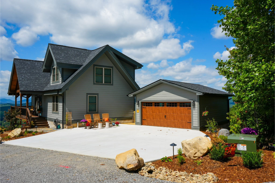 Completed residential home exterior with new construction and driveway, showcasing craftsmanship by Foothills Construction and Restoration Services in Forest City, NC. Call (828) 537-4470.