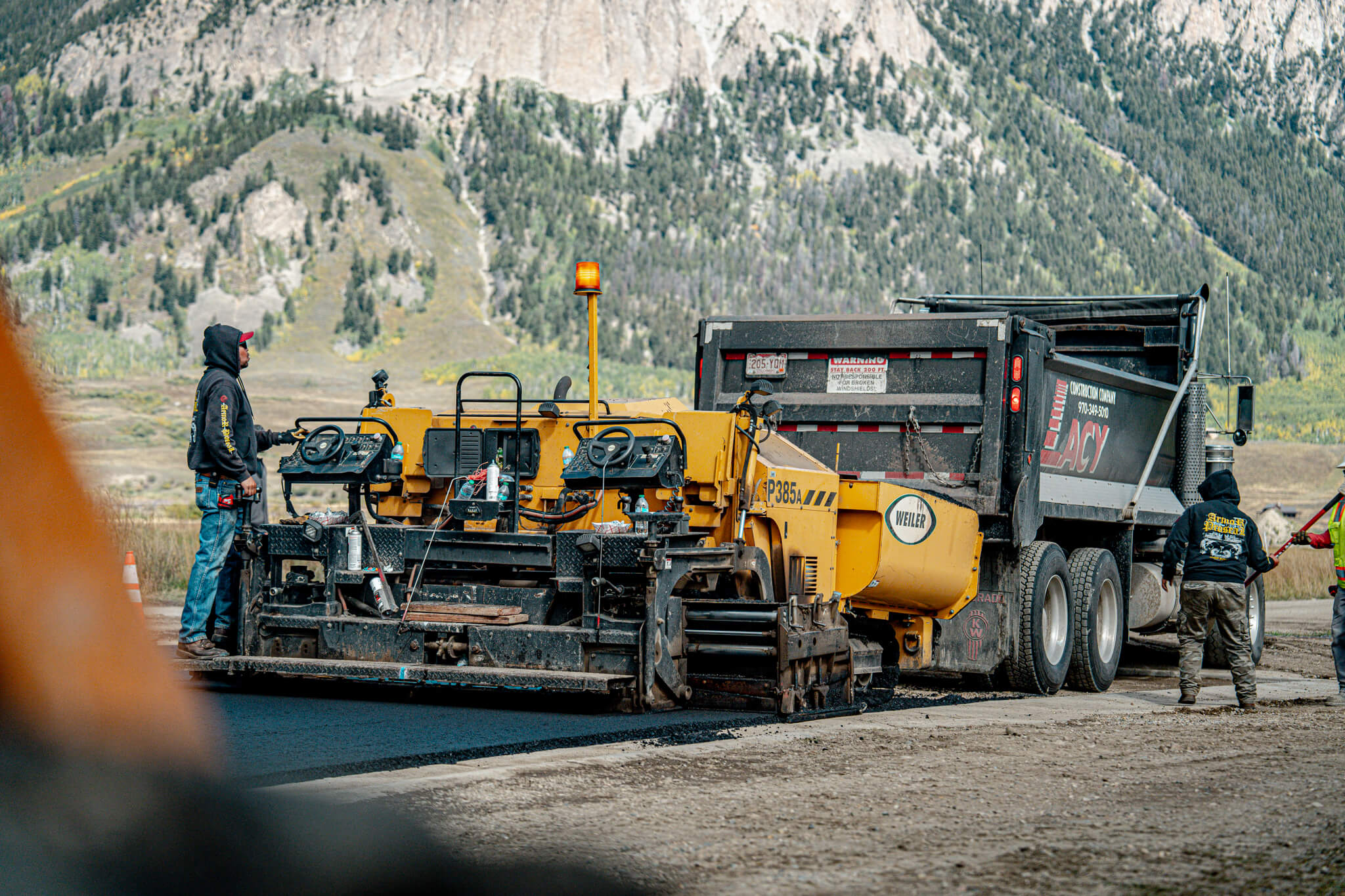 Armor Proseal team completing asphalt paving on a commercial property in Glenwood Springs, CO, demonstrating precision workmanship and professional equipment in mountain terrain conditions.