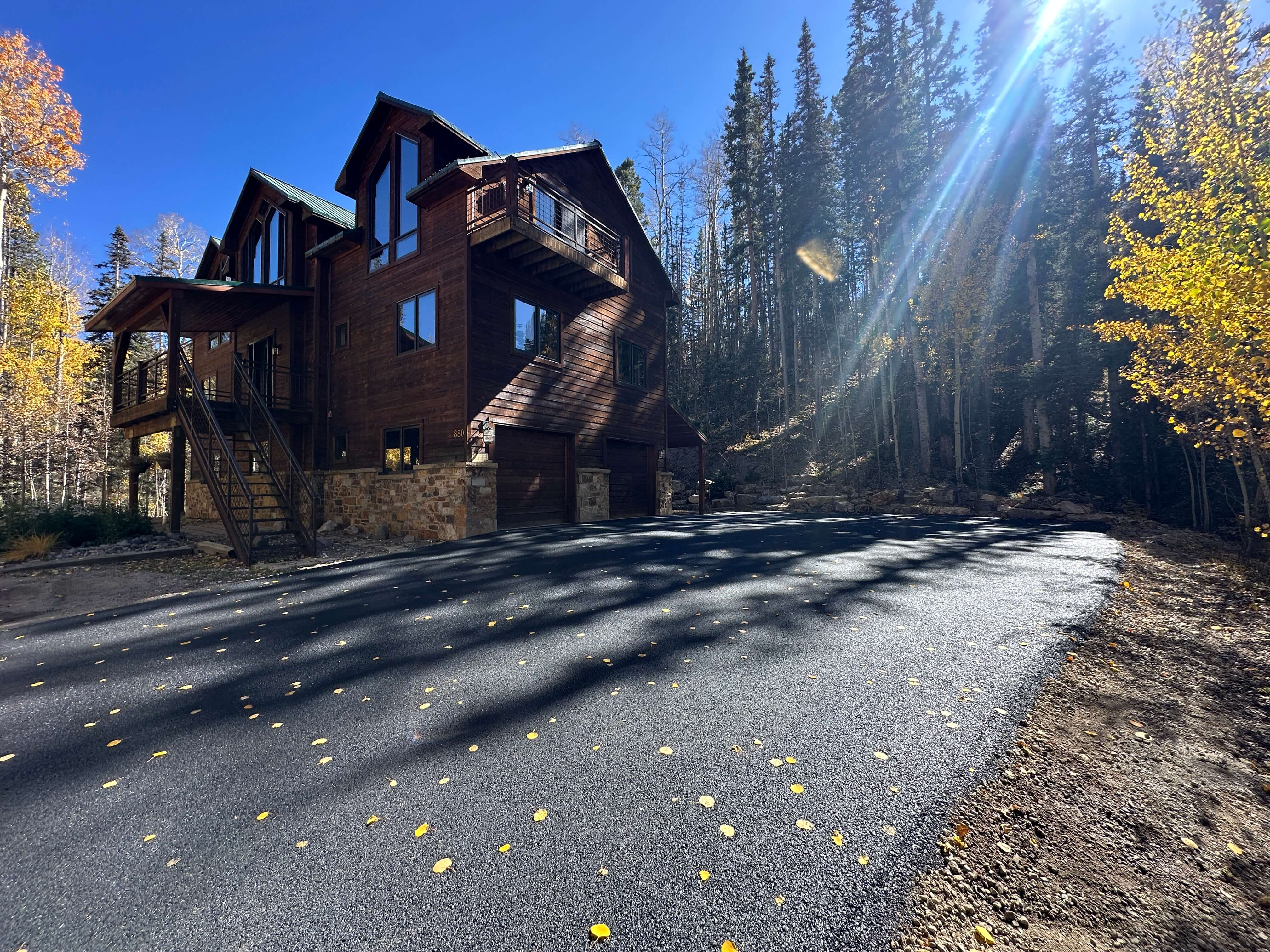 Recreational area access road repair at Vallecito, CO, with Armor Proseal equipment and crew improving tourism infrastructure with quality asphalt maintenance.