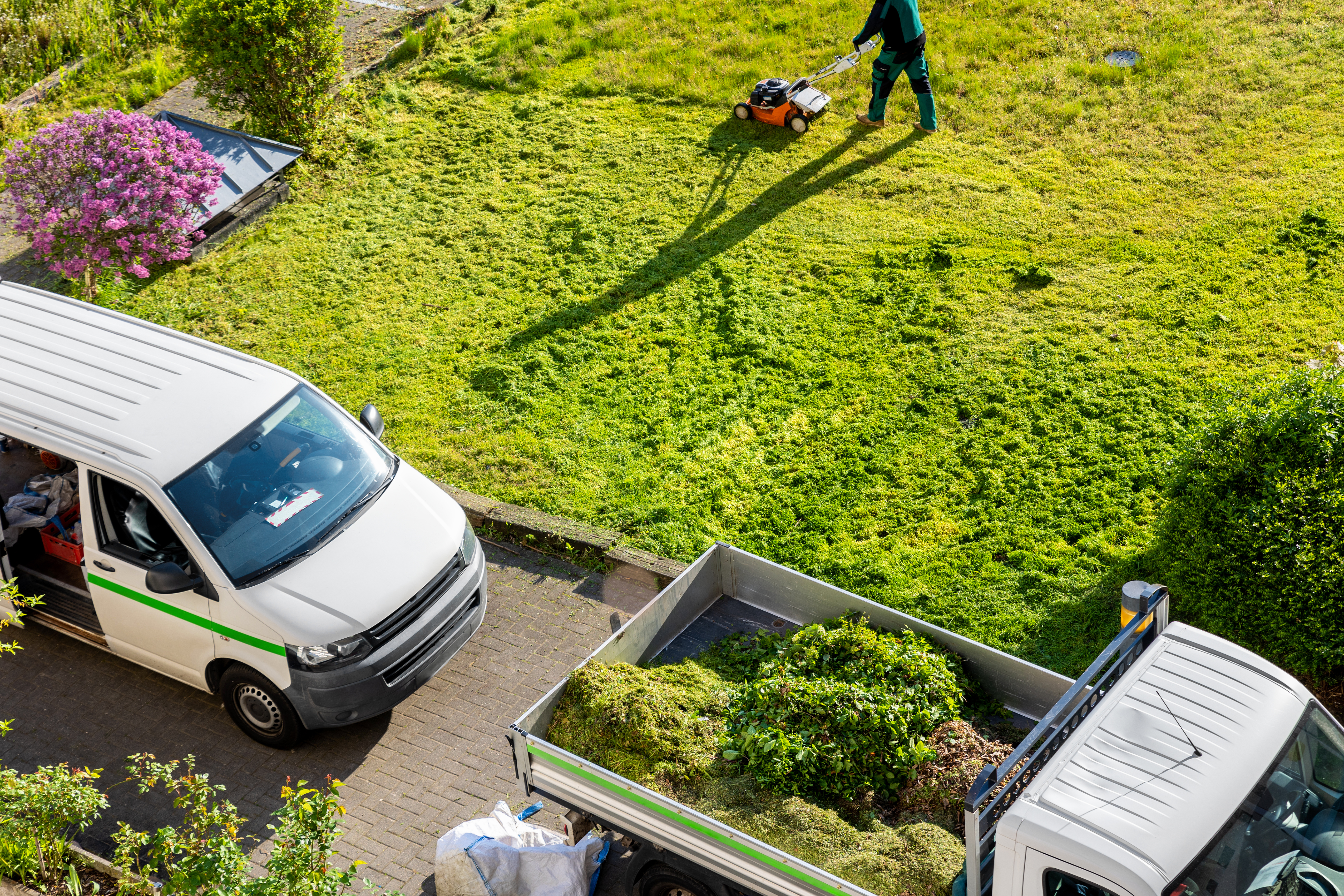 A property service crew removing weeds from a property and mowing