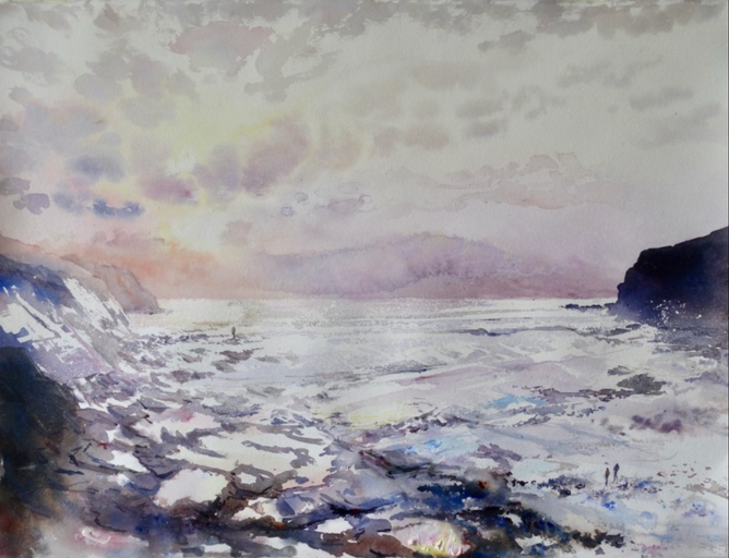 Looking down into the bay, sunlight reflected in rock pools, Crackington Haven, Cornwall.