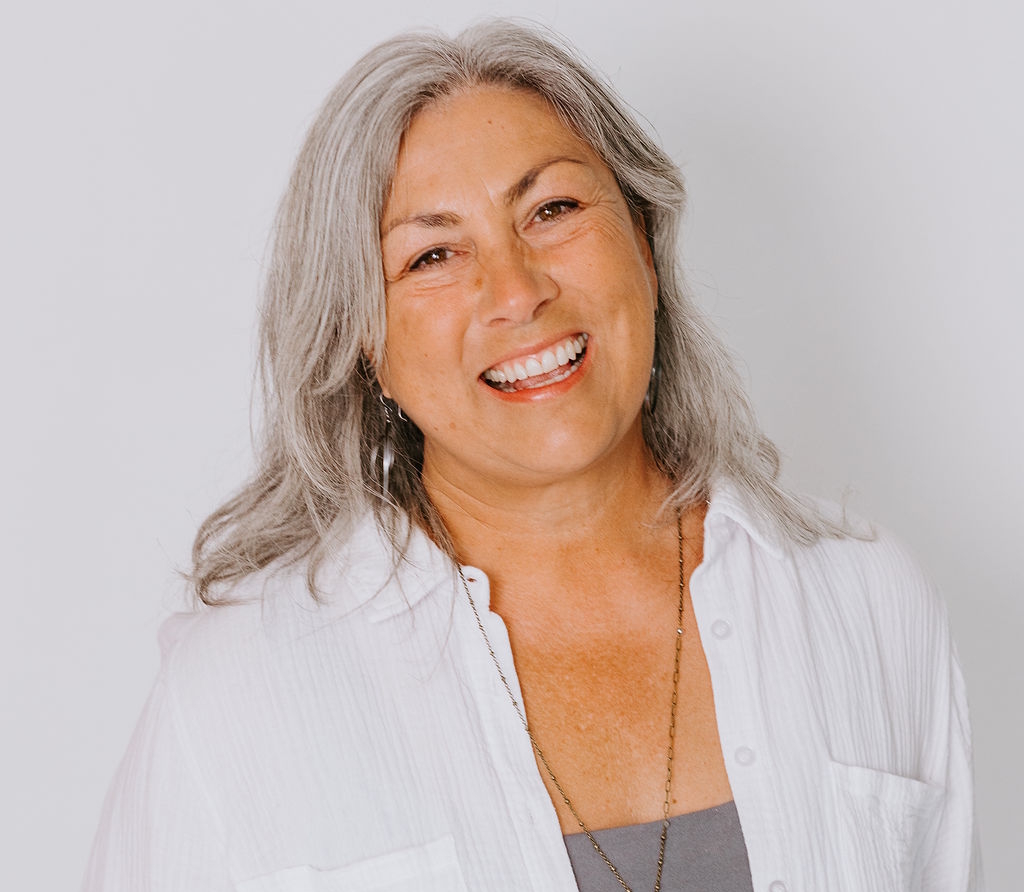 A woman is examining a man 's head in a lab