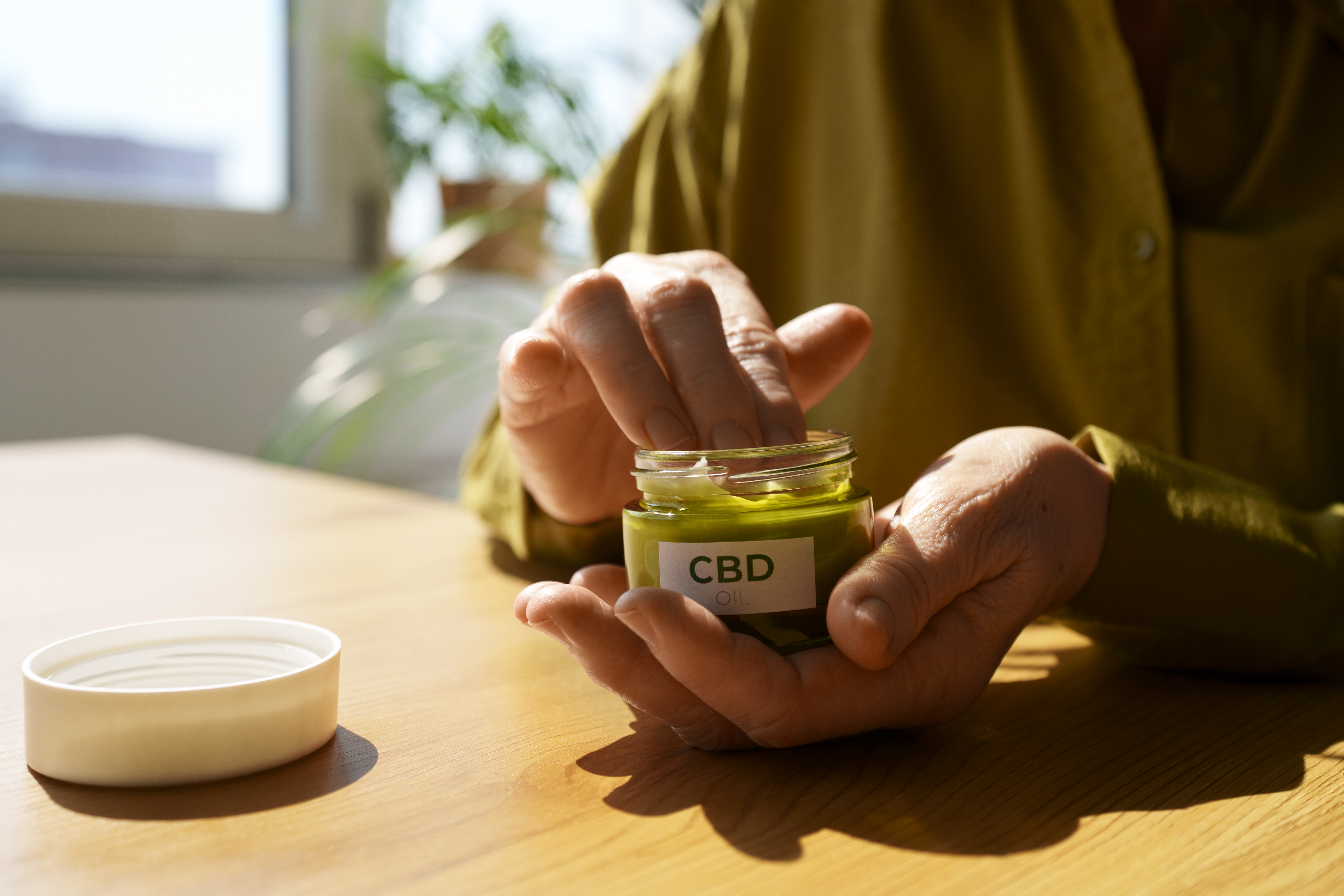 close-up-woman-using-cbd-cream-pain.jpg
