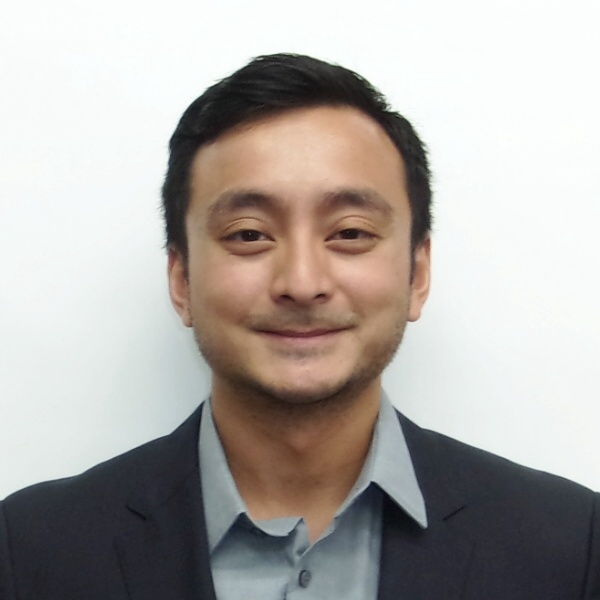 a woman wearing a black jacket and a red scarf is smiling for the camera .