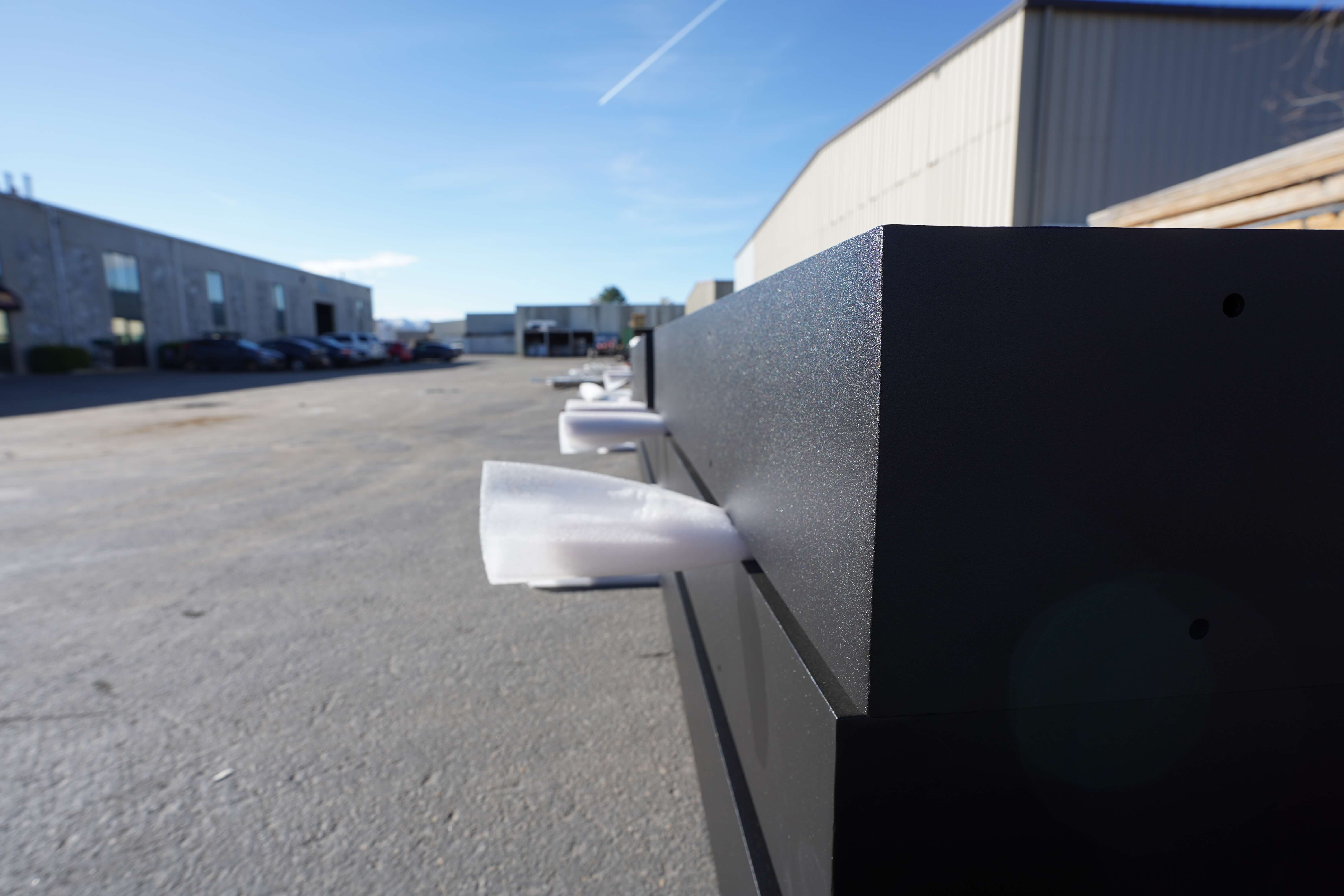 Side view of protective foam inserts on powder-coated metal parts placed in a lot.