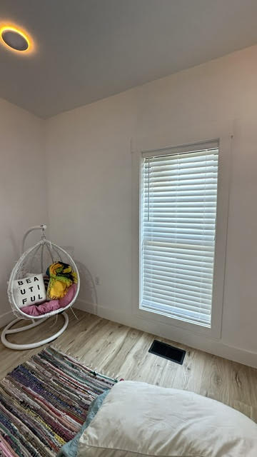 Faux wood blinds in a bedroom installed by Simmonds Blinds and Drapes in Bowling Green, KY. Call (270) 514-4492.